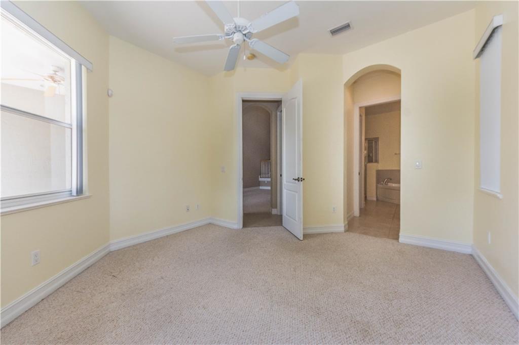 1855 Bridgepointe Circle, Unit 21 Vero Beach, FL 32967 - Photo 15 of 35 an empty room with a bathroom and a mirror