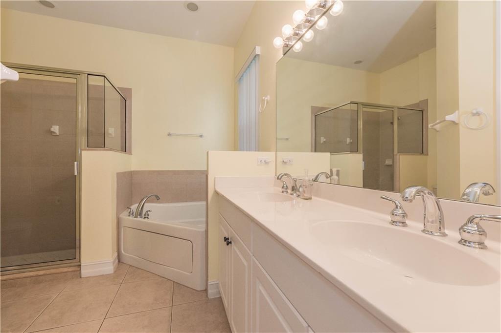 1855 Bridgepointe Circle, Unit 21 Vero Beach, FL 32967 - Photo 16 of 35 a bathroom with a sink double vanity and a mirror
