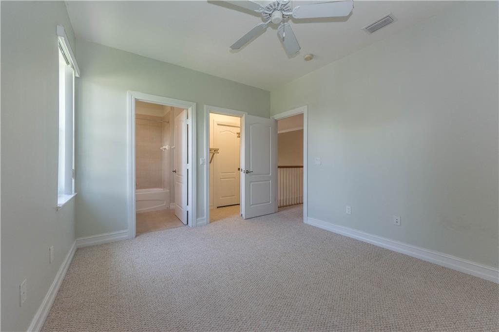 1855 Bridgepointe Circle, Unit 21 Vero Beach, FL 32967 - Photo 20 of 35 an empty room with fan and entrance