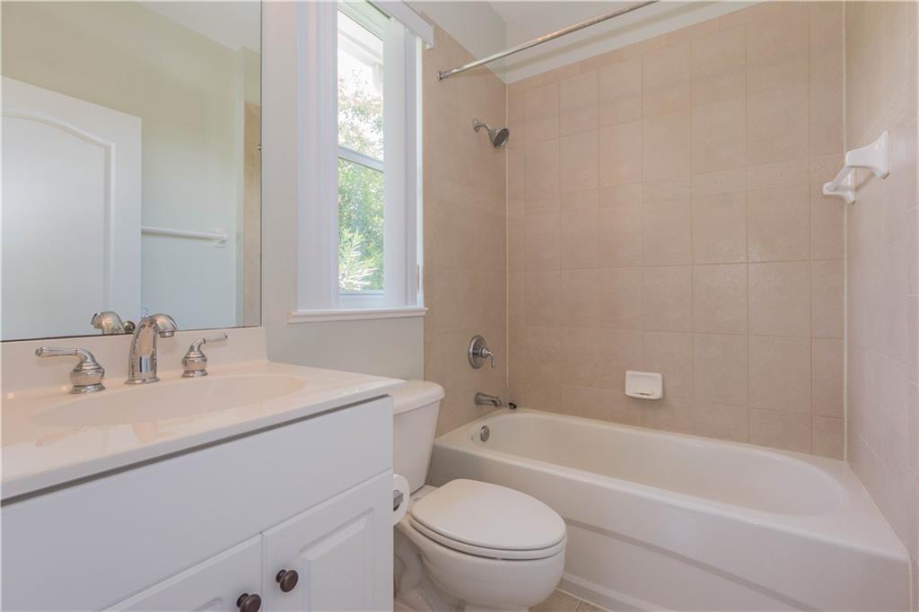 1855 Bridgepointe Circle, Unit 21 Vero Beach, FL 32967 - Photo 21 of 35 a bathroom with a sink toilet vanity and bathtub