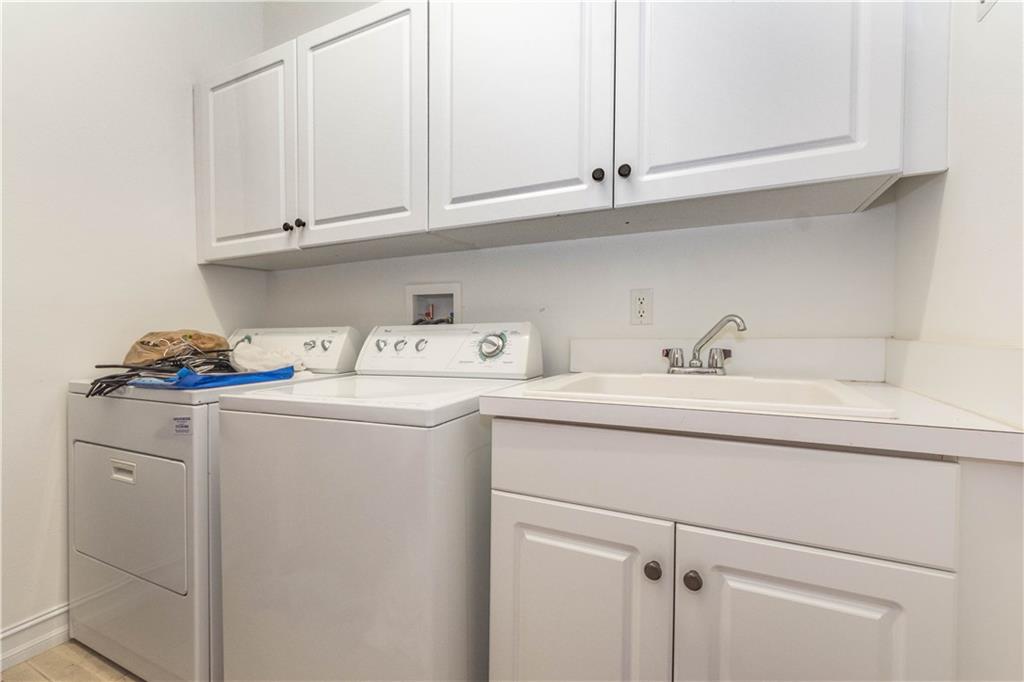 1855 Bridgepointe Circle, Unit 21 Vero Beach, FL 32967 - Photo 27 of 35 a utility room with cabinets washer and dryer