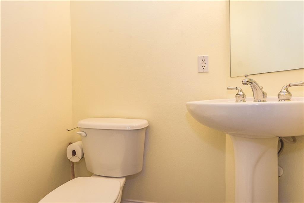 1855 Bridgepointe Circle, Unit 21 Vero Beach, FL 32967 - Photo 28 of 35 a bathroom with a toilet a sink and mirror