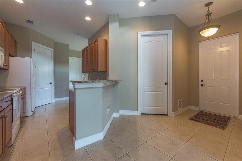 1855 Bridgepointe Circle, Unit 21 Vero Beach, FL 32967 - Photo 5 of 35 a bathroom with a sink a toilet and shower