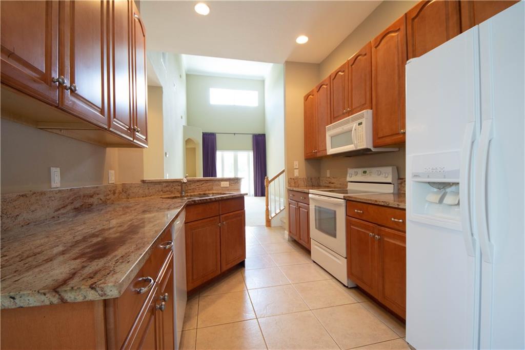 1855 Bridgepointe Circle, Unit 21 Vero Beach, FL 32967 - Photo 6 of 35 a kitchen with stainless steel appliances granite countertop a stove and a sink
