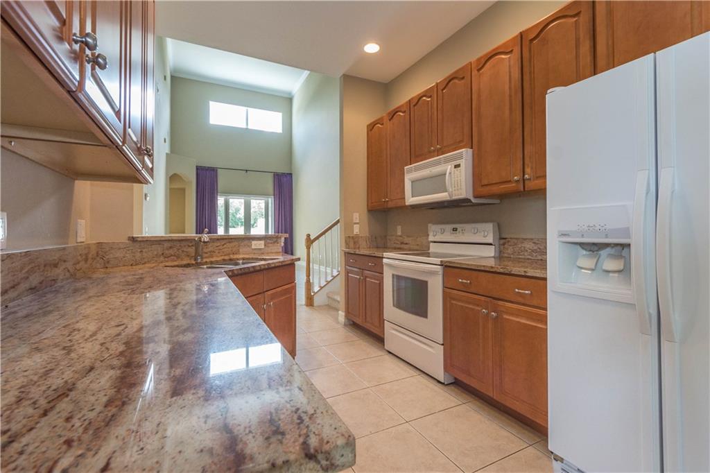 1855 Bridgepointe Circle, Unit 21 Vero Beach, FL 32967 - Photo 8 of 35 a kitchen with cabinets and stainless steel appliances