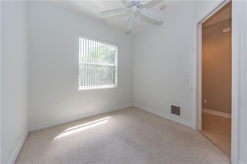 1855 Bridgepointe Circle, Unit 21 Vero Beach, FL 32967 - Photo 10 of 35 an empty room with a window