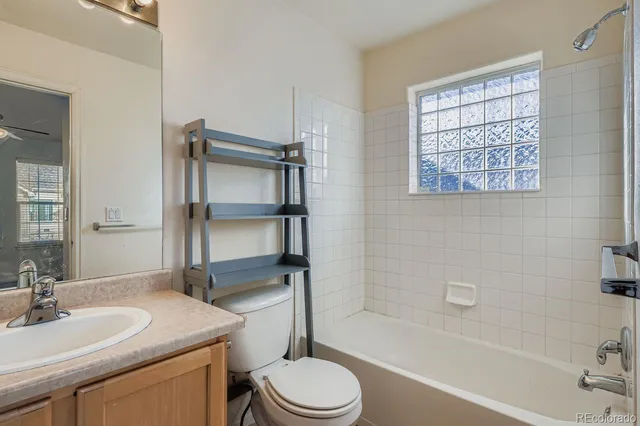 a bathroom with a sink toilet vanity and tub