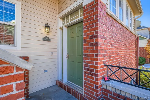 a view of a brick building with a door and a window
