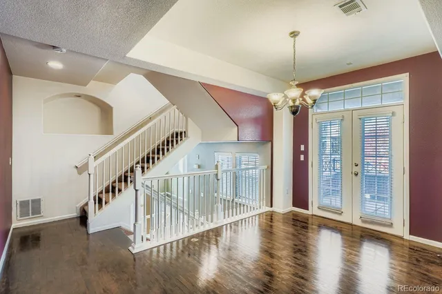 a view of empty room with wooden floor