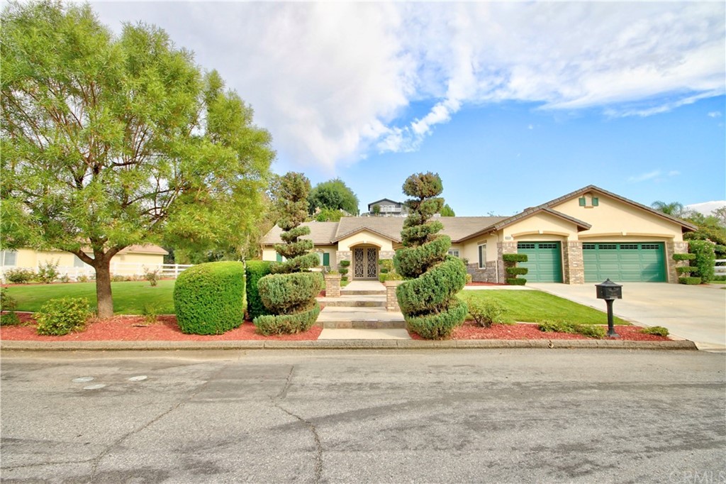 30099 Corte Coelho Temecula, CA 92591 - Photo 2 of 47 a front view of a house with a yard and garage