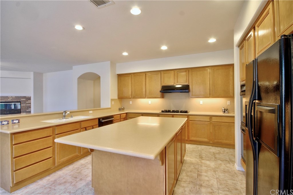 30099 Corte Coelho Temecula, CA 92591 - Photo 17 of 47 a kitchen with stainless steel appliances granite countertop a sink a stove and a refrigerator