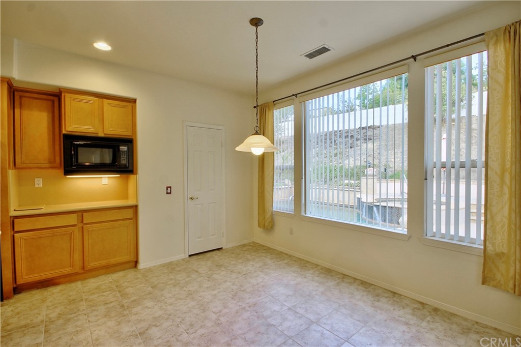 30099 Corte Coelho Temecula, CA 92591 - Photo 19 of 47 a view of an empty room with a window and a kitchen