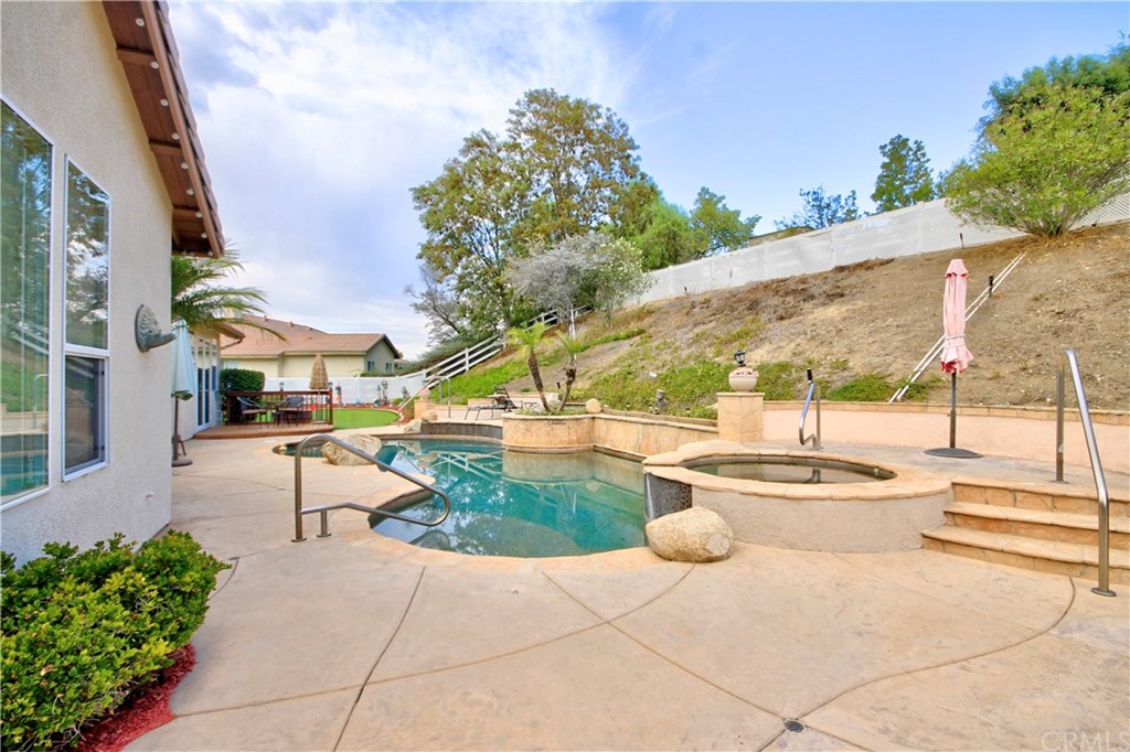 30099 Corte Coelho Temecula, CA 92591 - Photo 37 of 47 a view of a patio with dining table and chairs with wooden fence