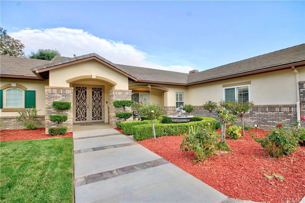 30099 Corte Coelho Temecula, CA 92591 - Photo 9 of 47 a front view of a house with a yard and potted plants