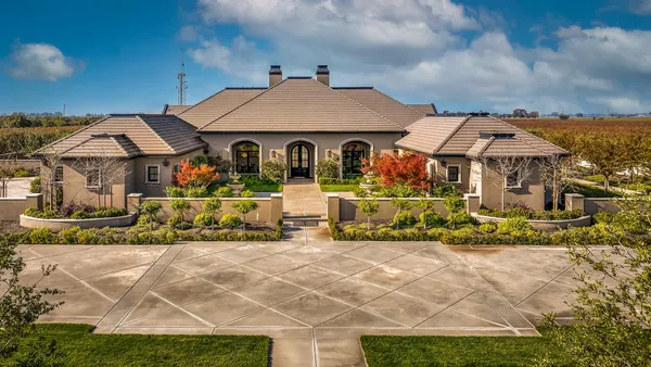 a view of a patio with a table and chairs
