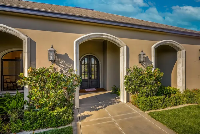 a kitchen with stainless steel appliances granite countertop a stove a refrigerator a sink dishwasher a dining table and chairs with wooden floor