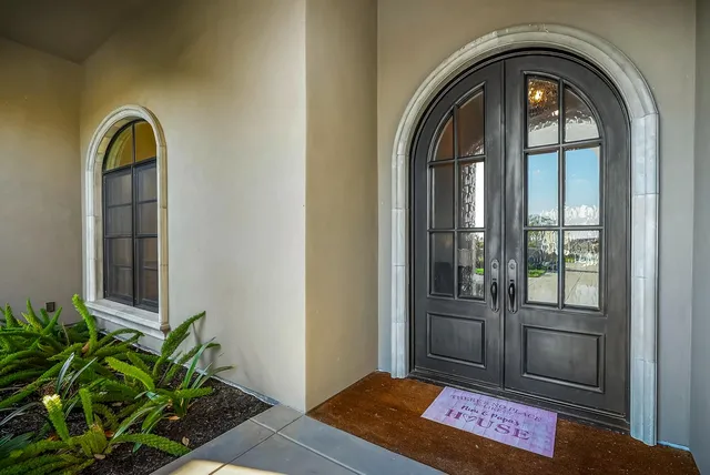 a kitchen with stainless steel appliances granite countertop a stove a sink and white cabinets