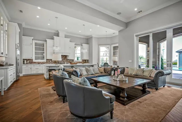a view of a dining room with furniture a chandelier and wooden floor