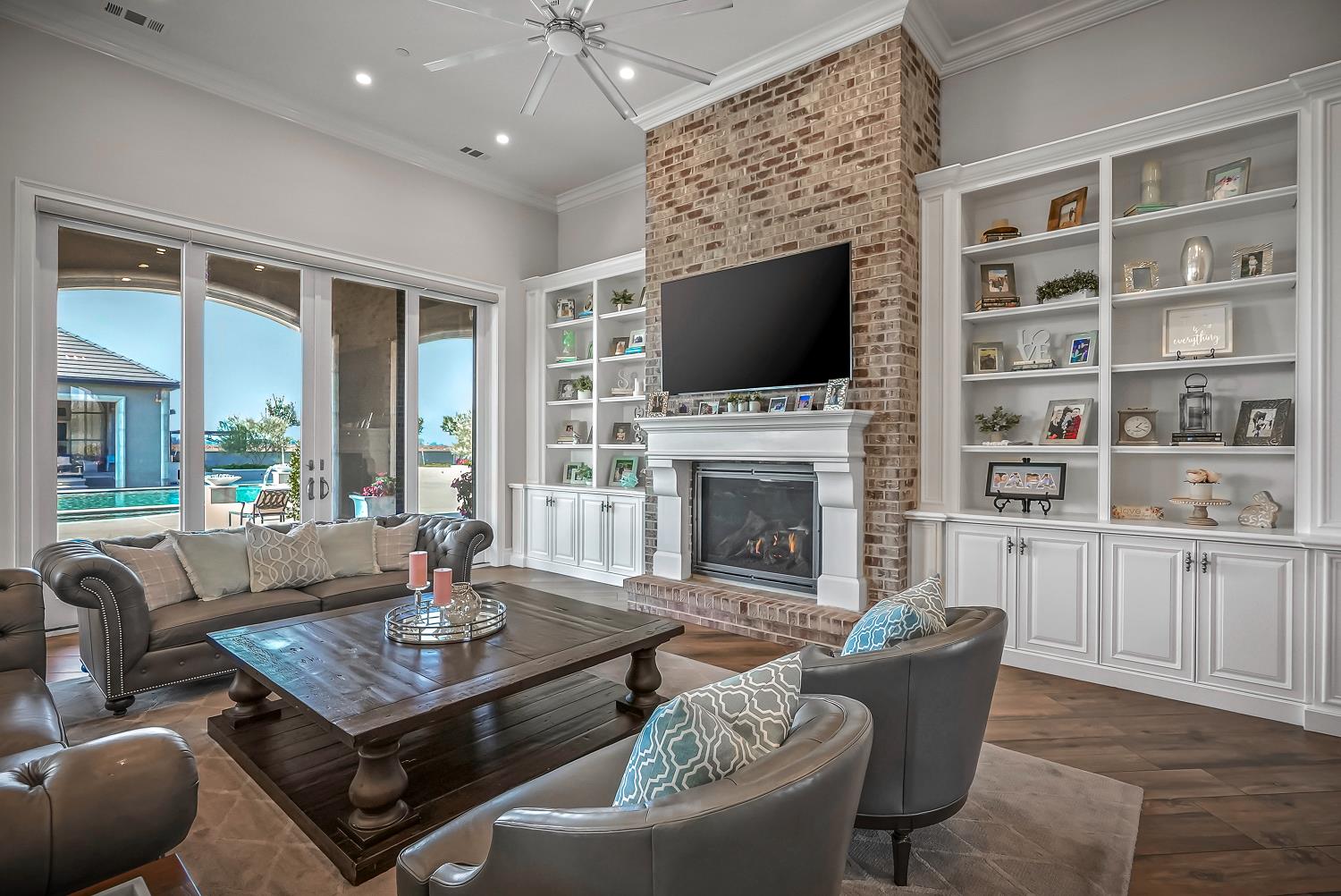 22215 Devries Road Lodi, CA 95242 - Photo 24 of 99 a living room with furniture a fireplace and a flat screen tv