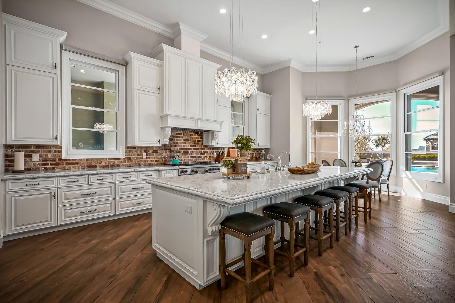 22215 Devries Road Lodi, CA 95242 - Photo 26 of 99 a kitchen with stainless steel appliances granite countertop a stove a refrigerator a sink dishwasher a dining table and chairs with wooden floor