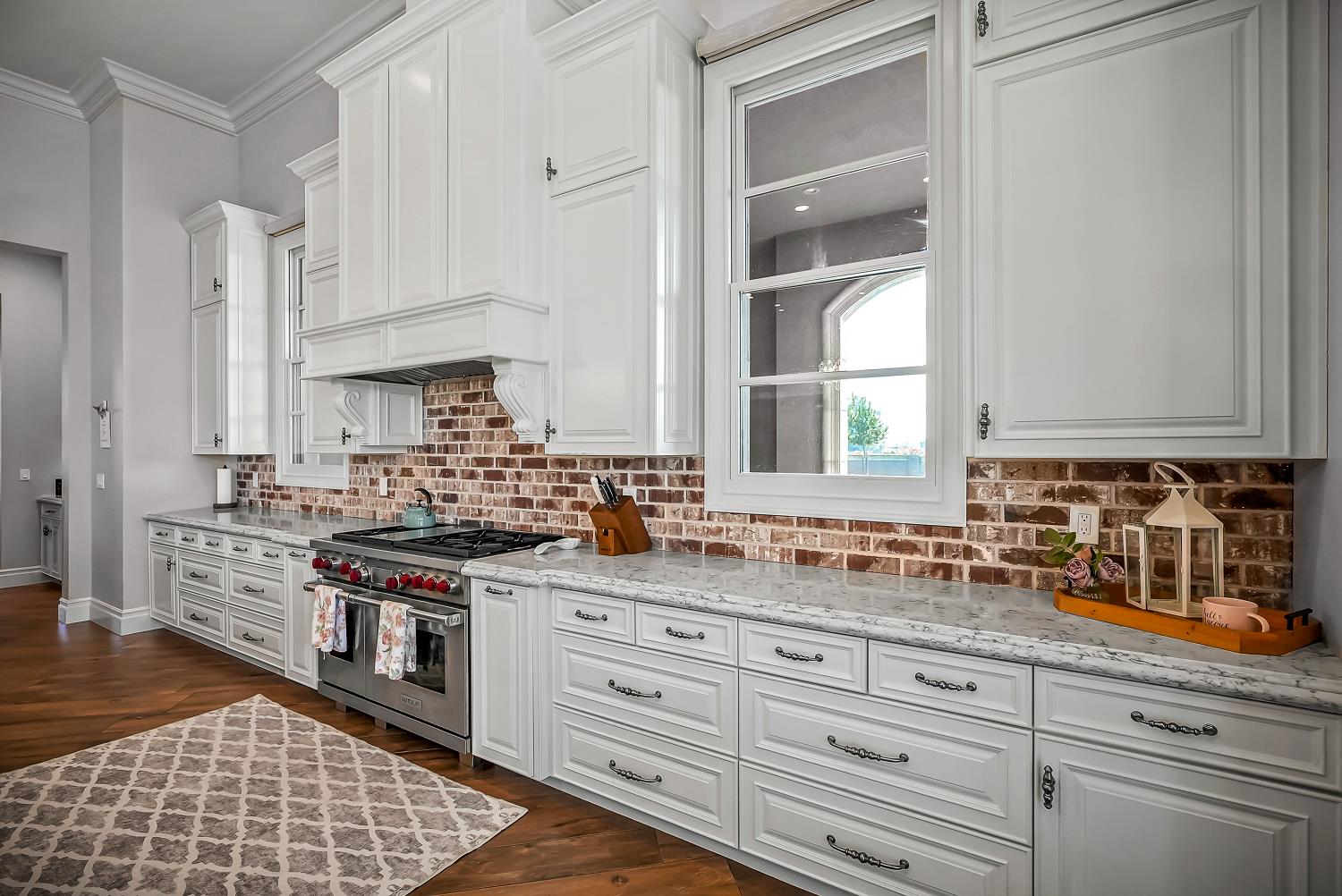 22215 Devries Road Lodi, CA 95242 - Photo 28 of 99 a kitchen with stainless steel appliances granite countertop a stove a sink and white cabinets