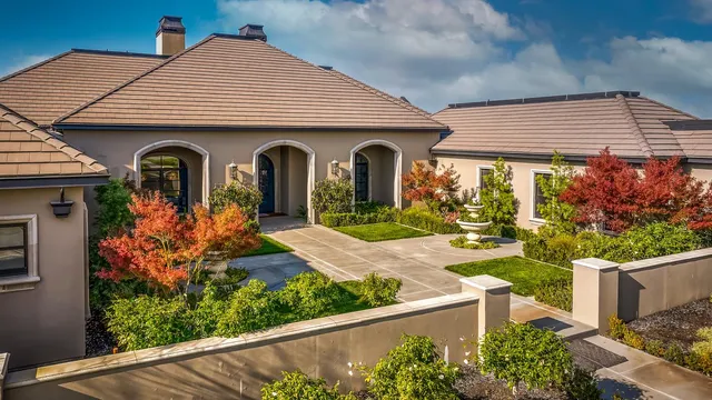 an aerial view of a swimming pool with outdoor seating and yard