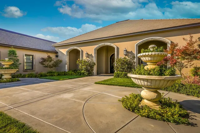 a front view of a house with garden