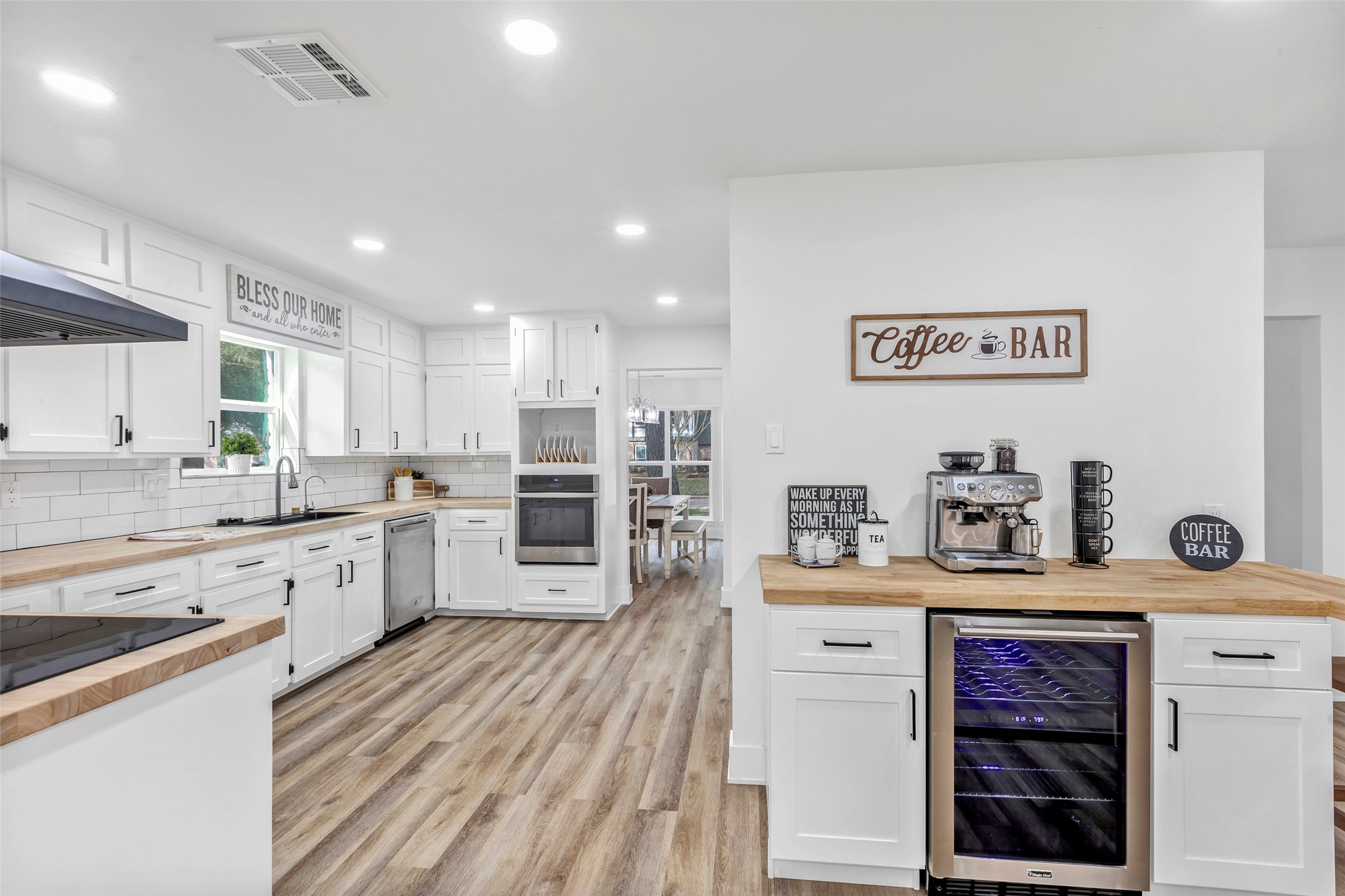 a kitchen with stainless steel appliances a refrigerator and a stove top oven