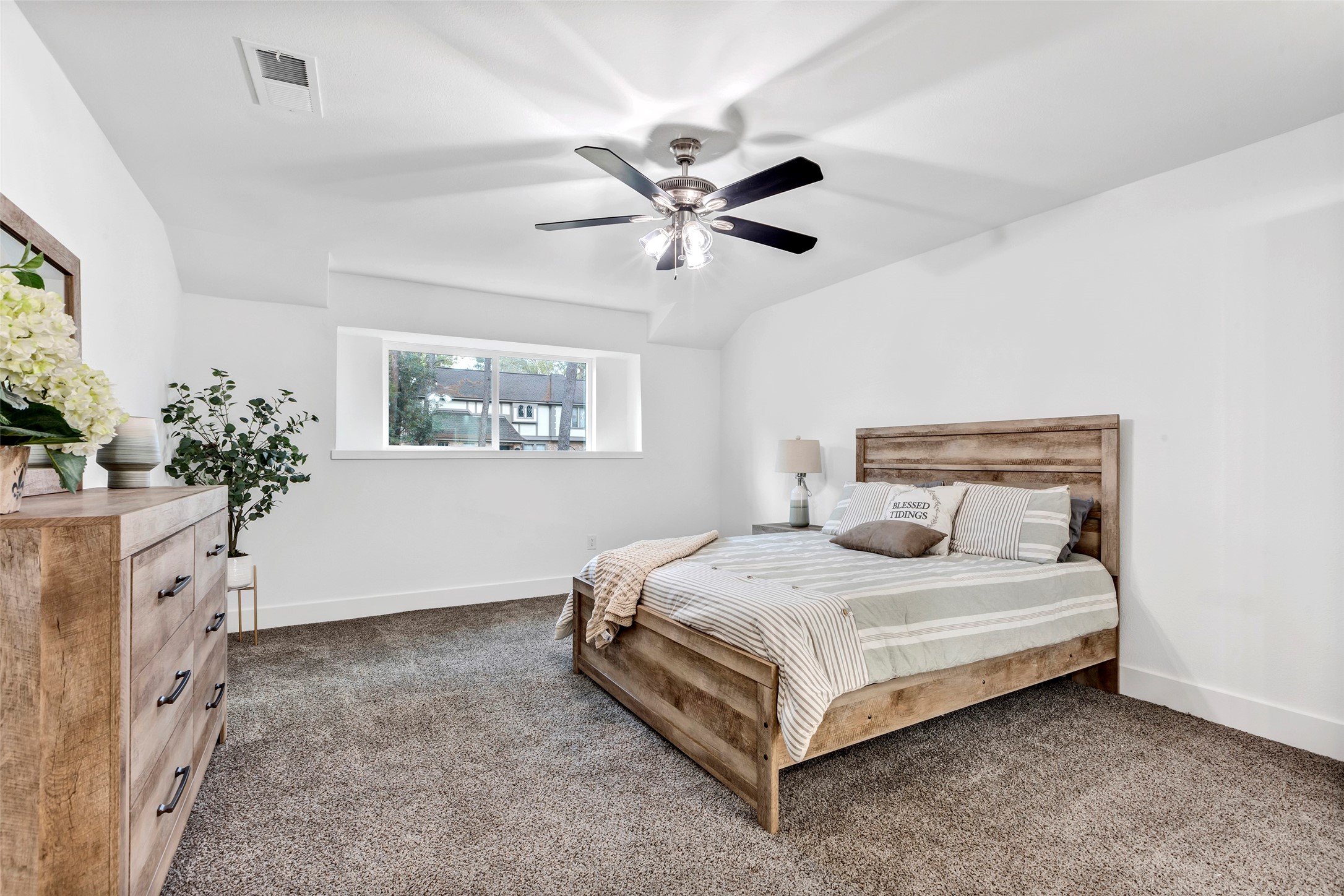 17207 Hill View Lane Spring, TX 77379 - Photo 16 of 34 a bedroom with a large bed chandelier and a window