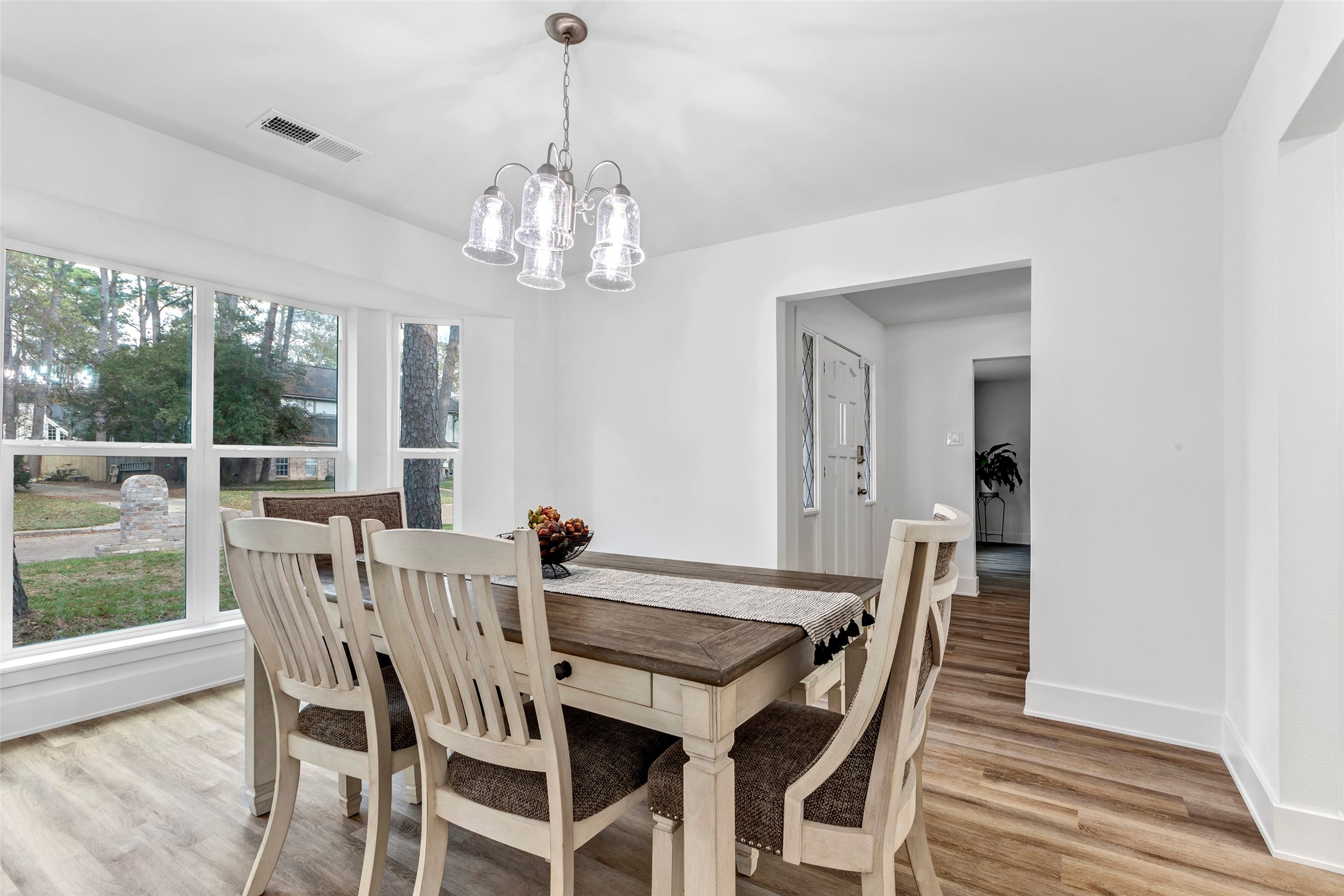 17207 Hill View Lane Spring, TX 77379 - Photo 4 of 34 a view of a dining room with furniture a chandelier and wooden floor