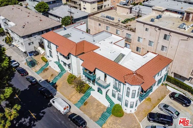 an aerial view of a house with a garden and trees