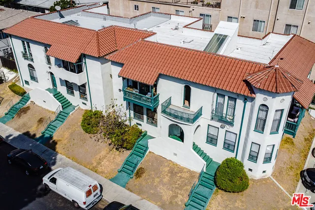 an aerial view of a house with a yard