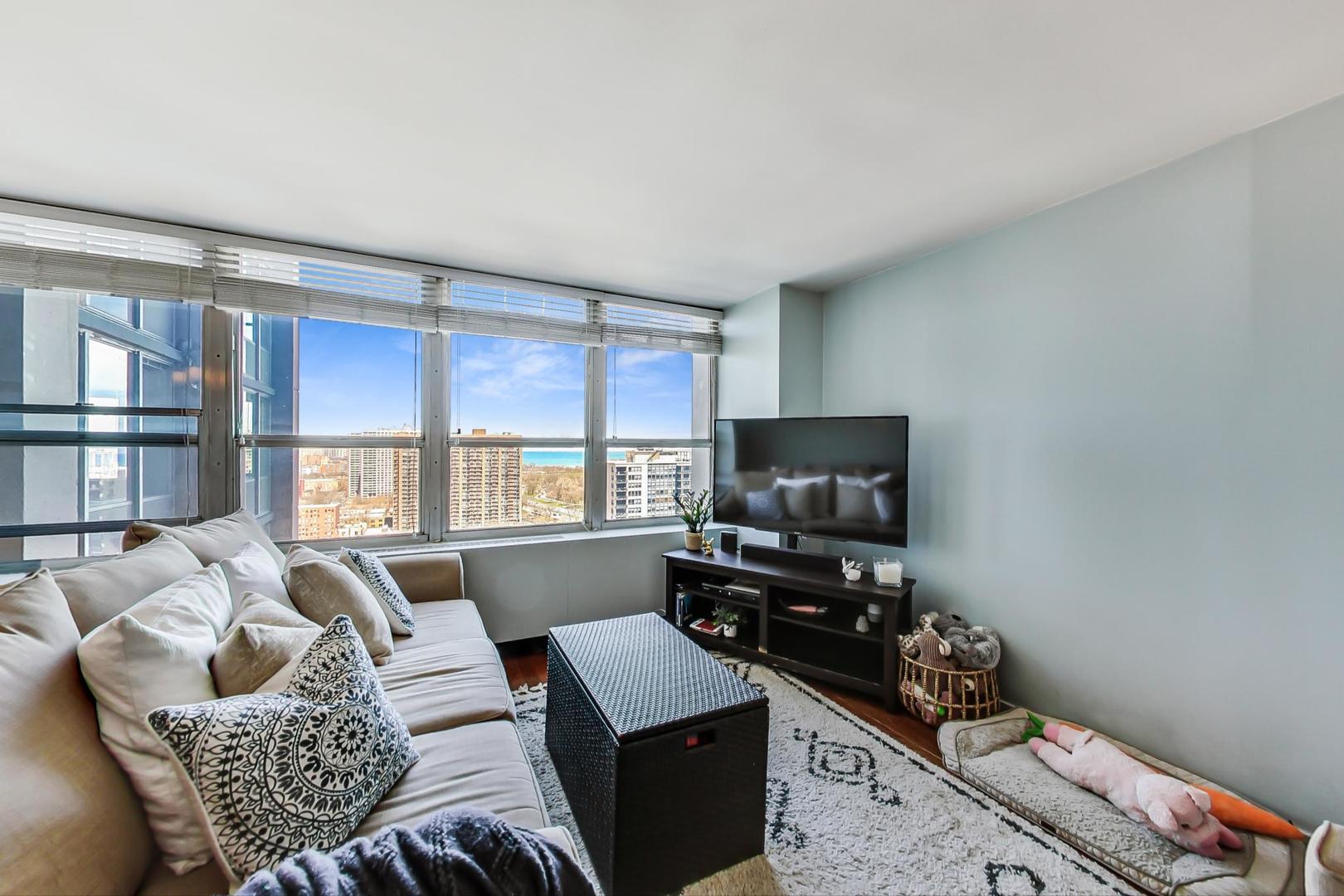655 West Irving Park Road, Unit 2108 Chicago, IL 60613 - Photo 10 of 34 a living room with furniture and a flat screen tv