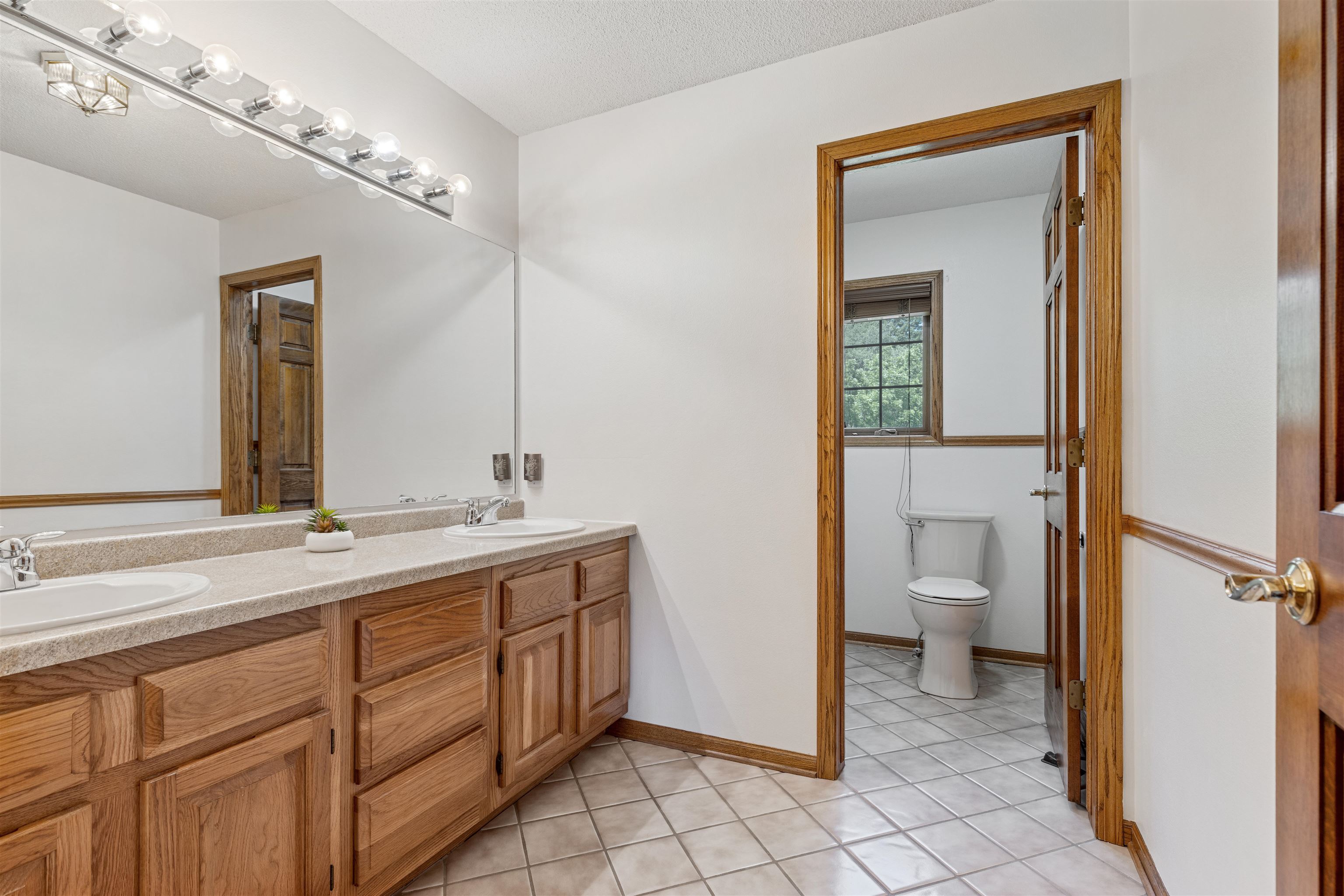 11136 Moate Road Durand, IL 61024 - Photo 27 of 55 a spacious bathroom with a sink a toilet and a mirror