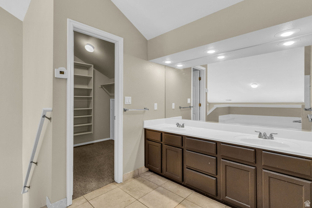 14108 Pepi Band Road Draper, UT 84020 - Photo 30 of 36 Double vanity with integrated sinks, ample storage cabinetry, and an expansive wall-mounted mirror with recessed lighting