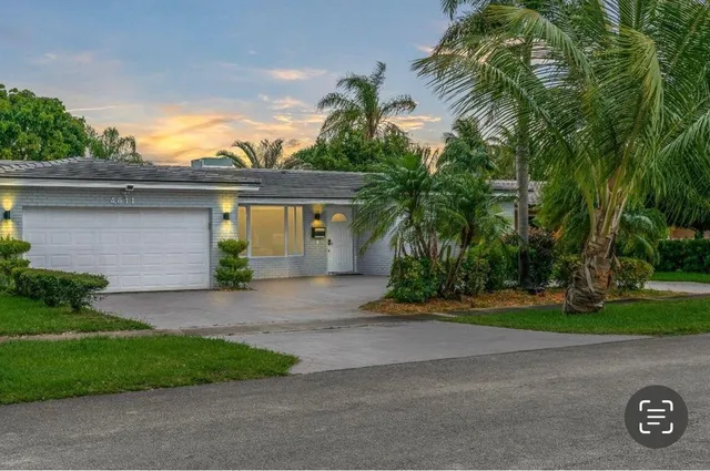 a front view of a house with a yard and a garage