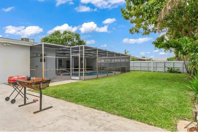 a view of a chair and table in backyard of the house