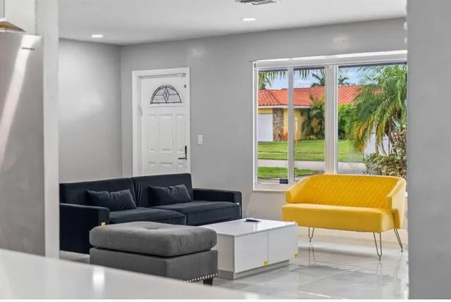 a living room with furniture and a large window