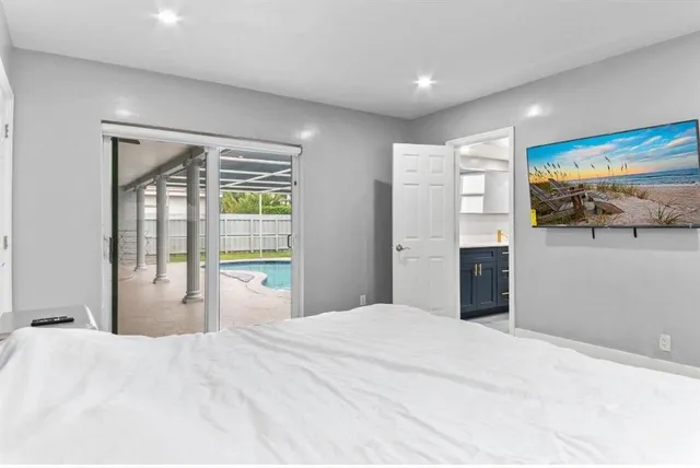 a bedroom with a bed and a flat screen tv