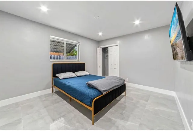 a room with a bed and a flat screen tv