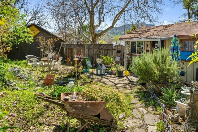a view of a patio with table and chairs and potted plants