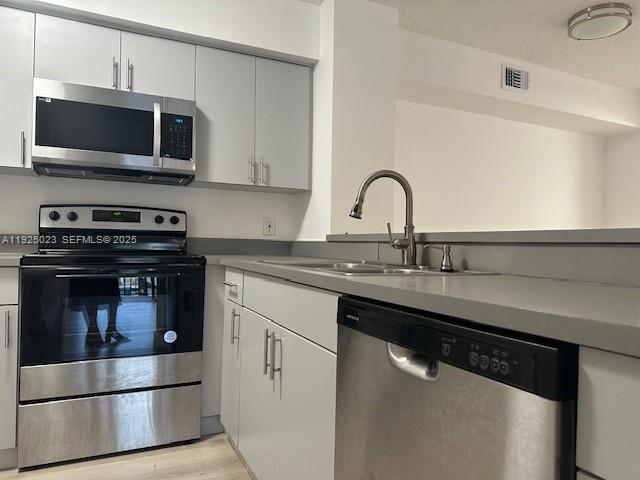 640 South Park Road, Unit 264 Hollywood, FL 33021 - Photo 9 of 14 a kitchen with a sink and stainless steel appliances