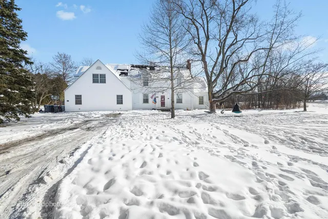 a white house that has a tree in it