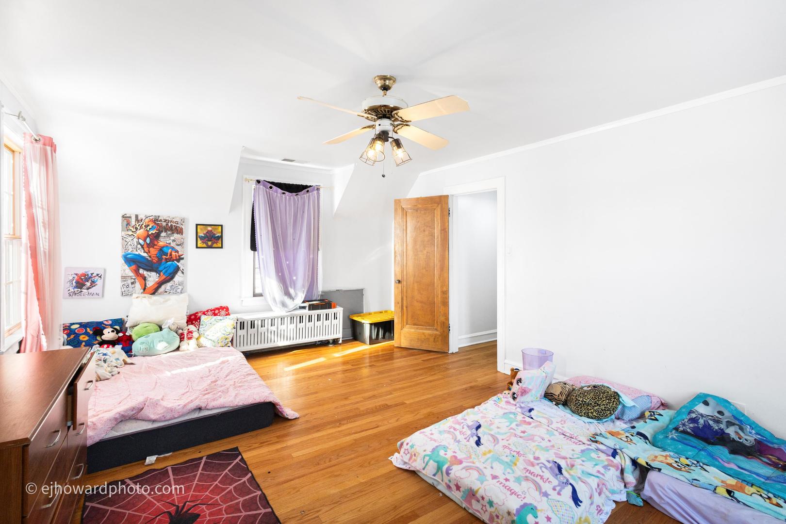 3655 Kent Place Crete, IL 60417 - Photo 16 of 29 a bedroom with a bed and a chandelier