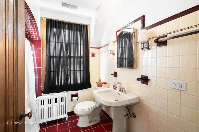 a bathroom with a sink a toilet and shower curtain