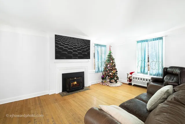 a living room with furniture fireplace and window
