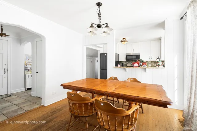 a view of a dining room with furniture and a chandelier