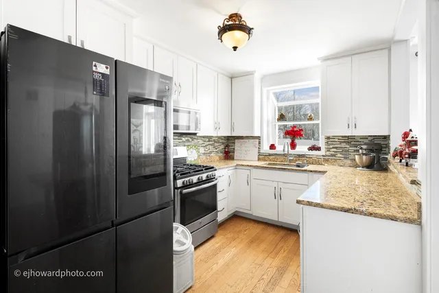 a kitchen with stainless steel appliances granite countertop a refrigerator stove microwave and sink
