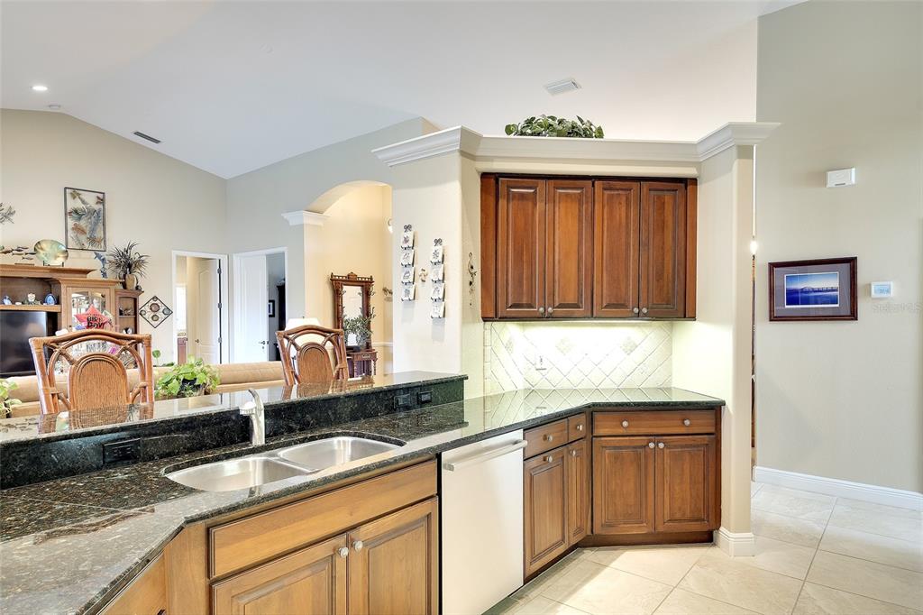 11809 Oak Ridge Drive Parrish, FL 34219 - Photo 13 of 39 a kitchen with granite countertop a sink and a stove