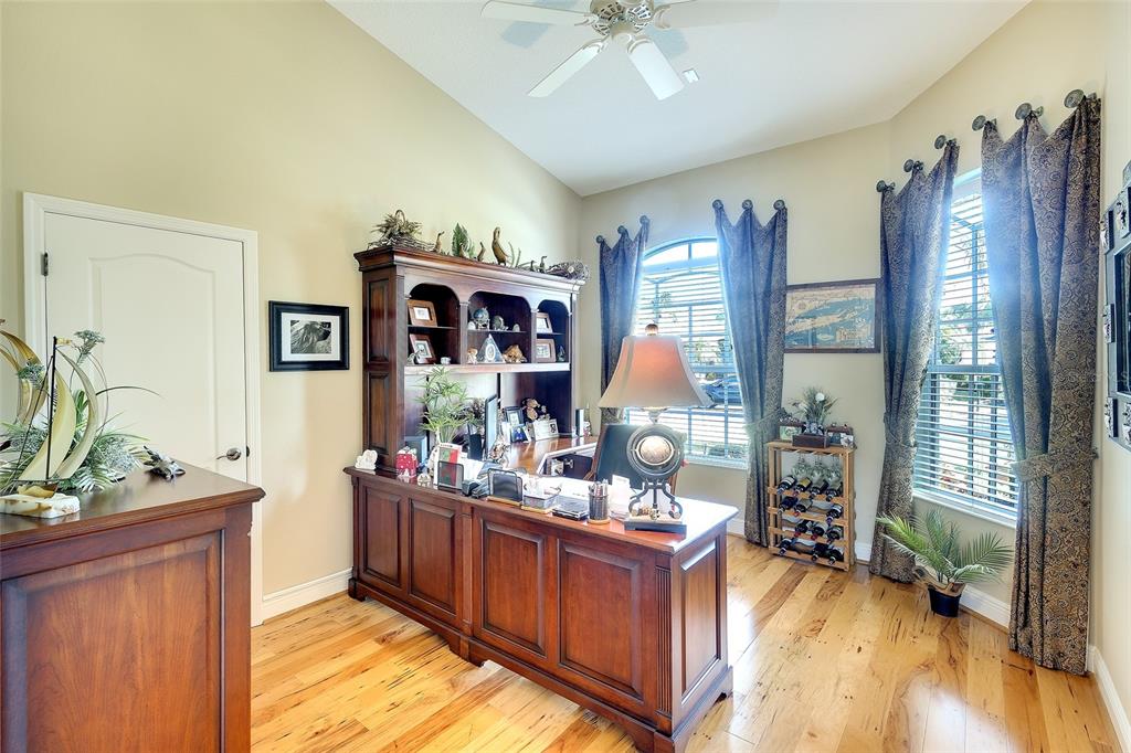 11809 Oak Ridge Drive Parrish, FL 34219 - Photo 16 of 39 a living room with furniture windows and a flat screen tv
